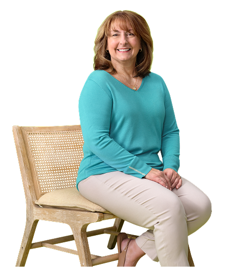 JoBeth, mother to Karabeth who is living with XLH, sitting on a wooden chair and smiling